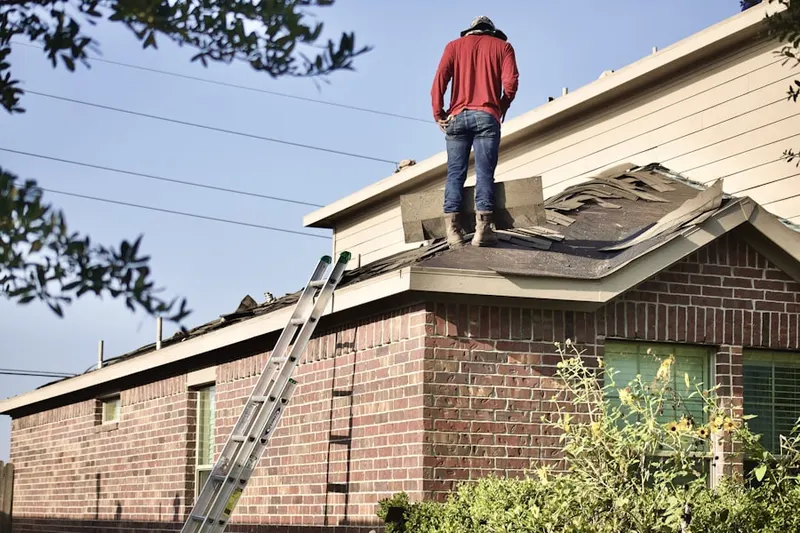 Professional roofer working on a residential roof in Mostoller
